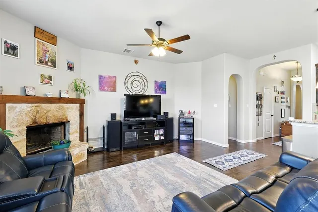 a living room with furniture and a fireplace