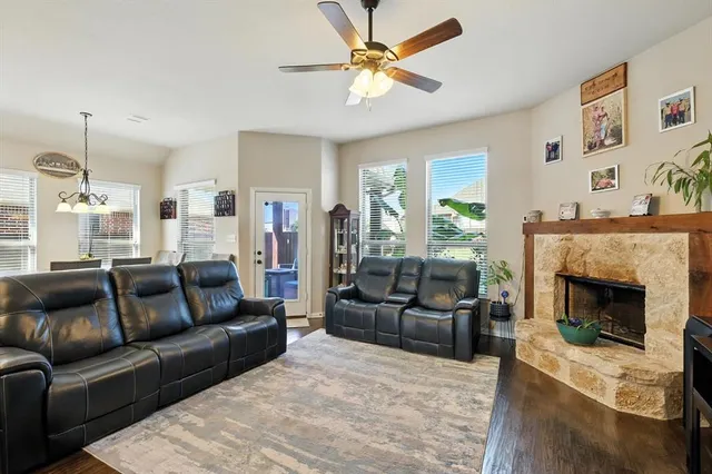a living room with furniture a flat screen tv and a fireplace