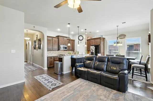 a kitchen with granite countertop stove top oven and refrigerator