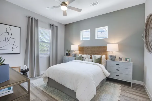 a bedroom with a bed and a chandelier