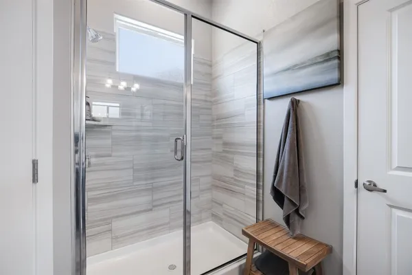 a bathroom with a shower and a glass door