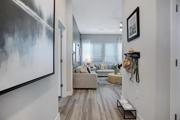 a living room with couches and painting on the wall