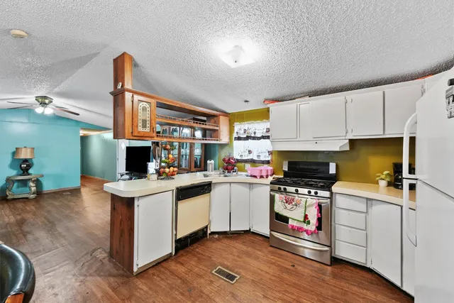 a kitchen with a sink cabinets and wooden floor