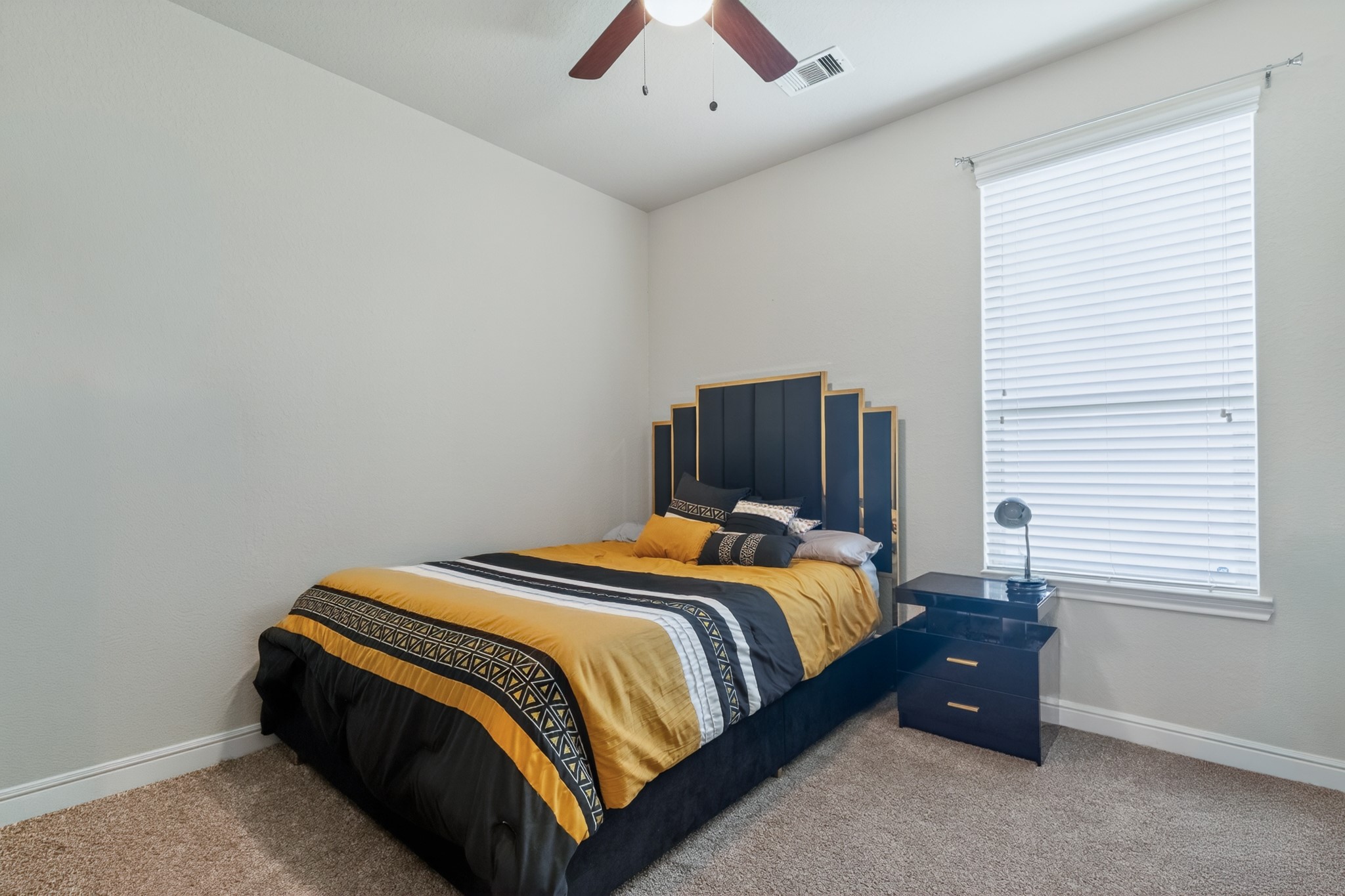 24711 East Burnaby Circle Spring, TX 77373 - Photo 15 of 20 a bedroom with a bed and a chandelier