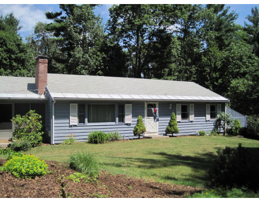 a front view of house with yard and green space