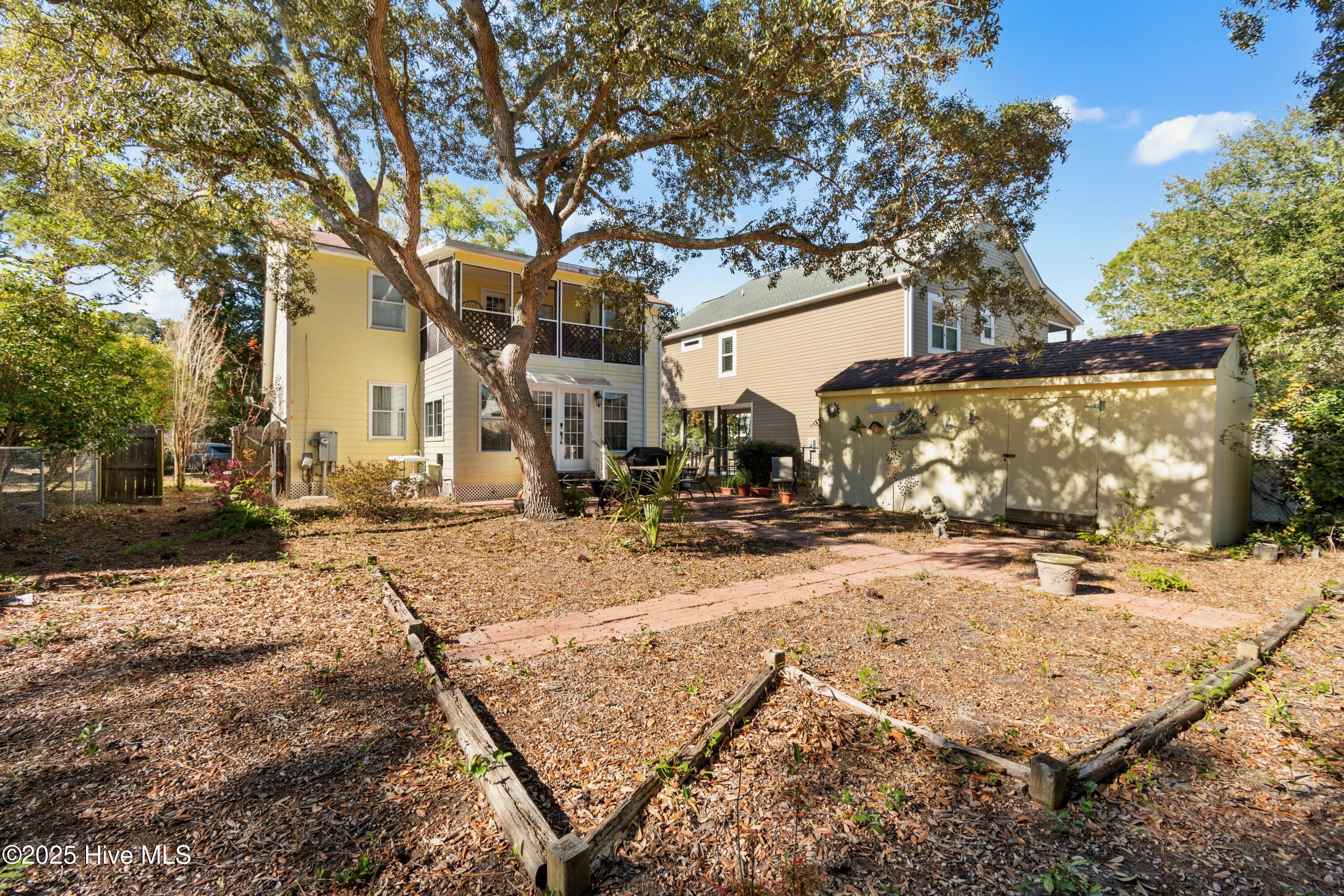 166 Northwest 7th Street Oak Island, NC 28465 - Photo 32 of 39 back yard and building