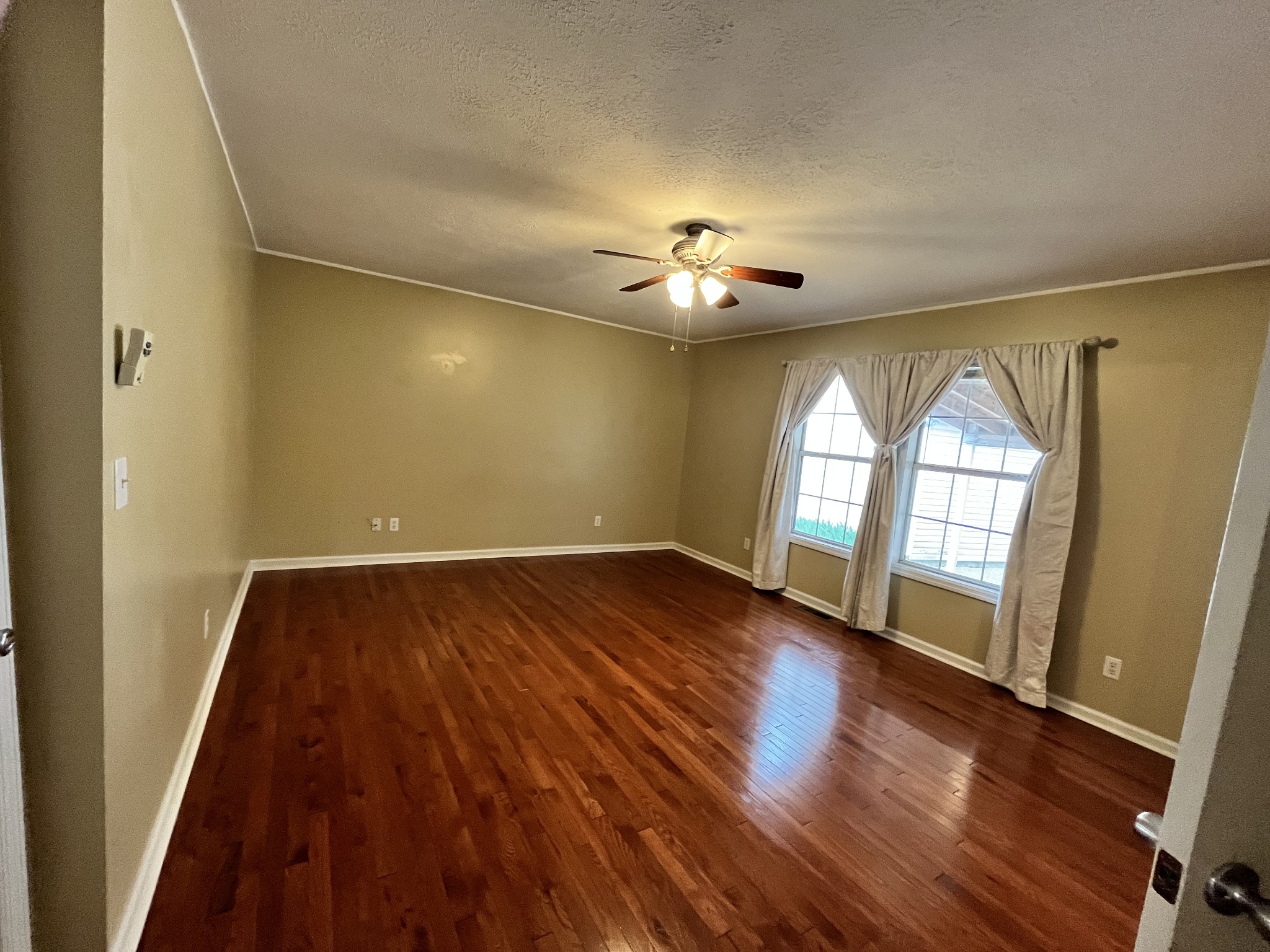 1763 Highway 166 Mount Pleasant, TN 38474 - Photo 11 of 40 wooden floor in an empty room with a window
