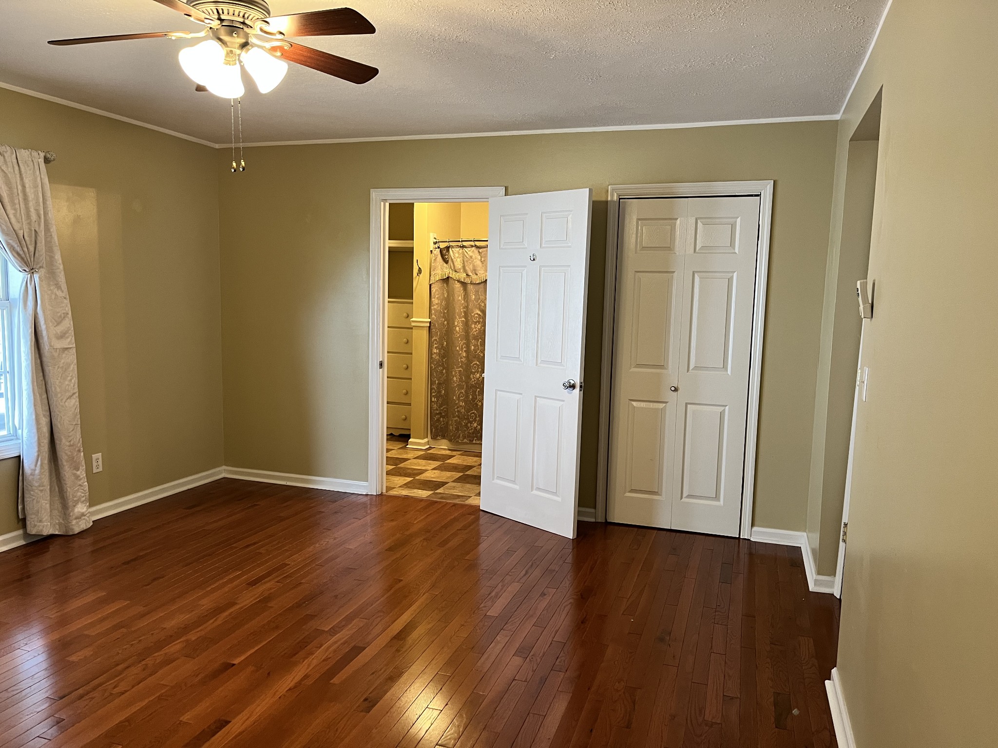 1763 Highway 166 Mount Pleasant, TN 38474 - Photo 13 of 40 a view of an empty room with wooden floor and a window