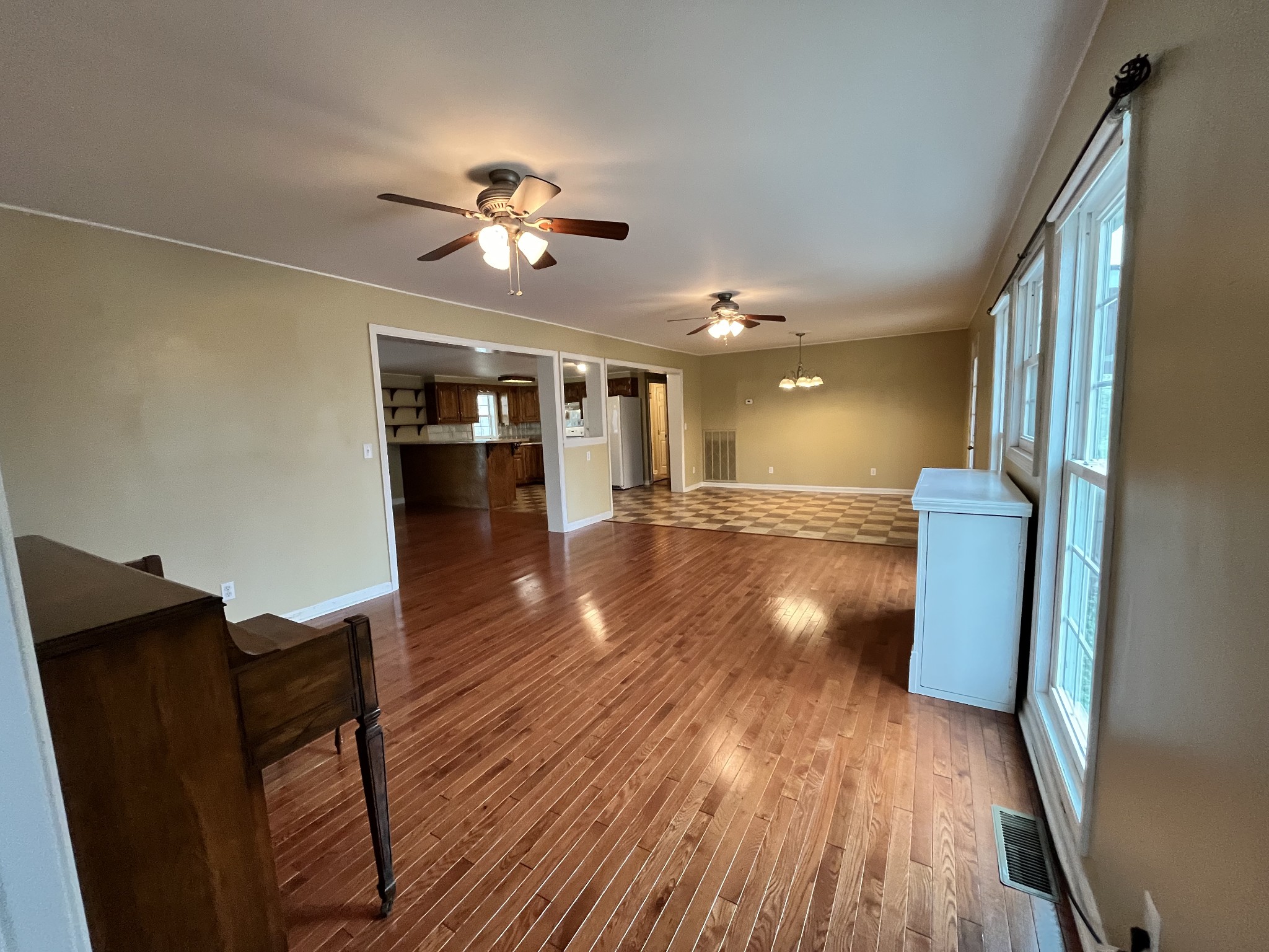 1763 Highway 166 Mount Pleasant, TN 38474 - Photo 16 of 40 a view of a livingroom with wooden floor and a ceiling fan