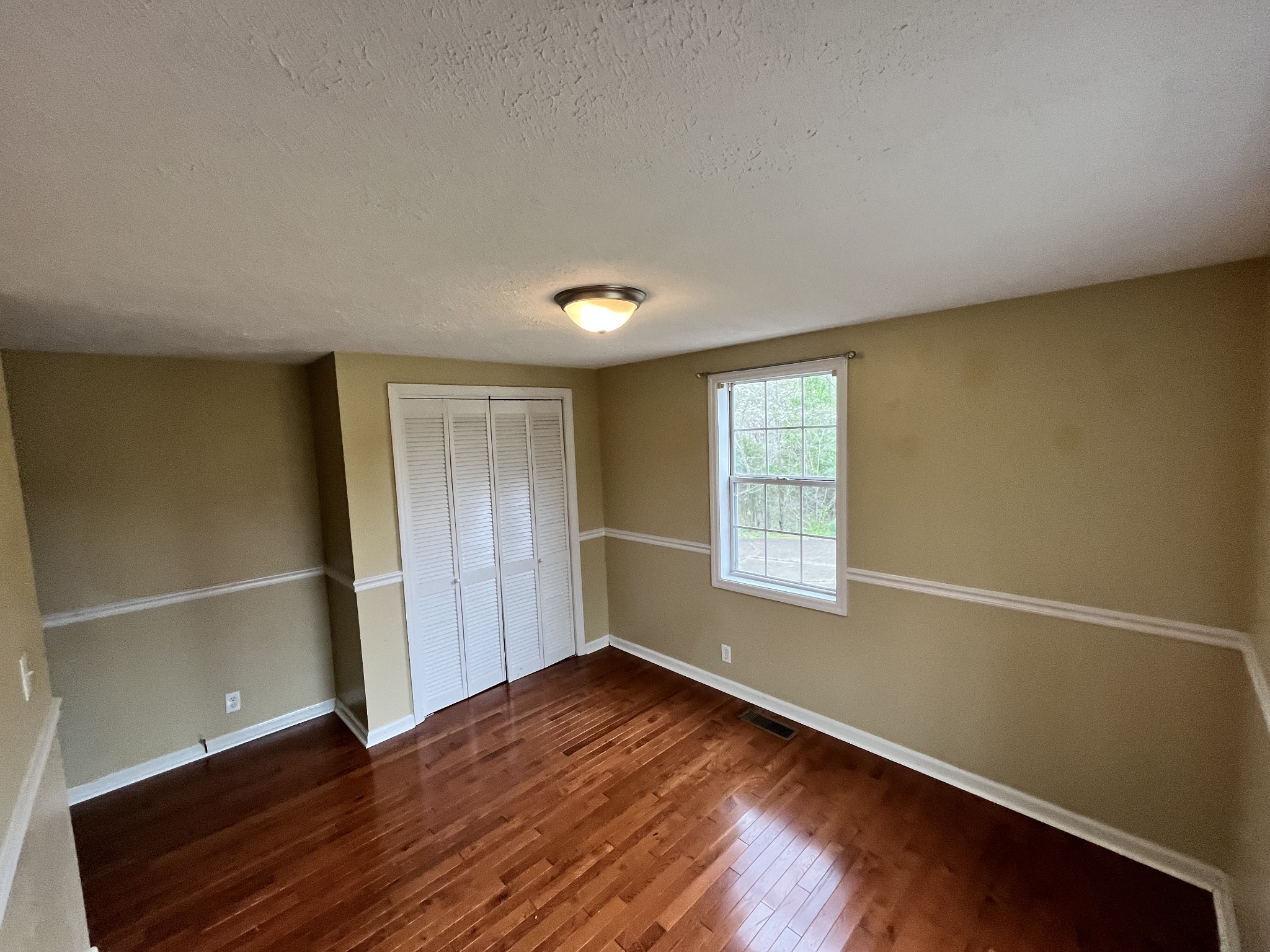 1763 Highway 166 Mount Pleasant, TN 38474 - Photo 25 of 40 a view of empty room with wooden floor and fan