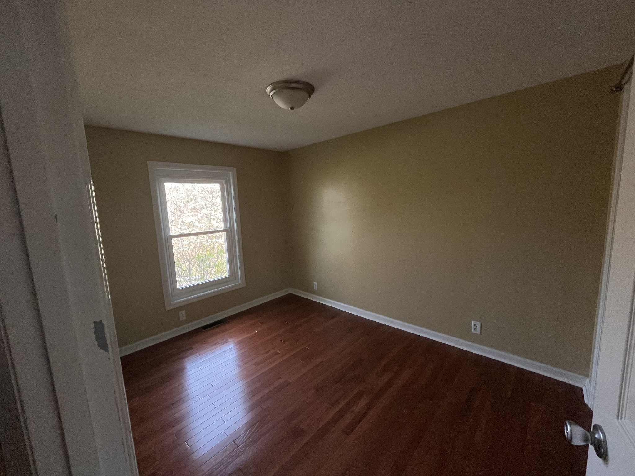1763 Highway 166 Mount Pleasant, TN 38474 - Photo 27 of 40 an empty room with wooden floor and windows