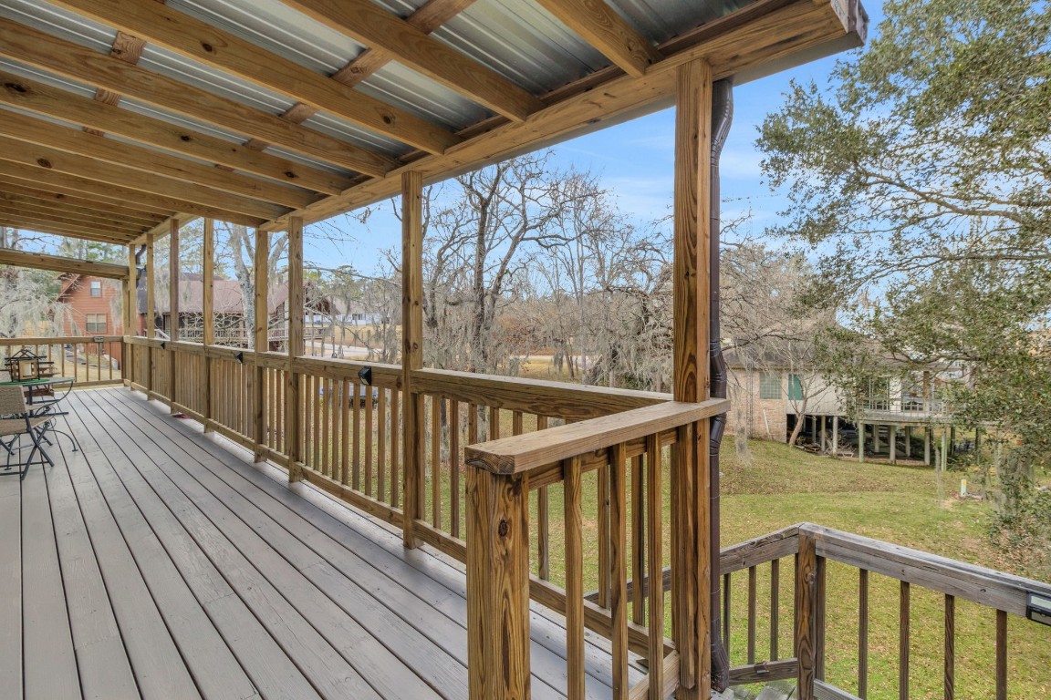 171 Kings Way Coldspring, TX 77331 - Photo 14 of 50 Steps from this deck lead to the expansive screened in porch and back yard