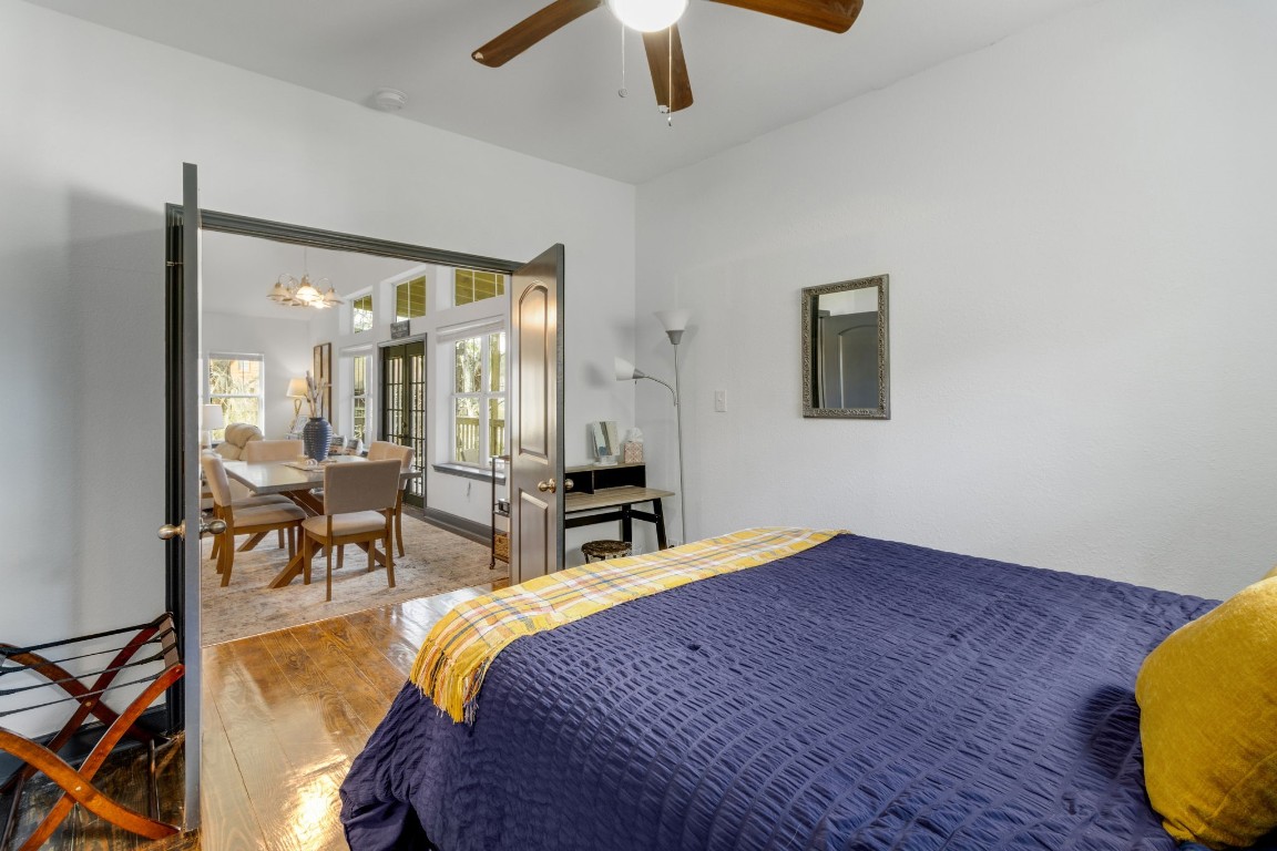 171 Kings Way Coldspring, TX 77331 - Photo 20 of 50 a bedroom with a bed a chandelier and window