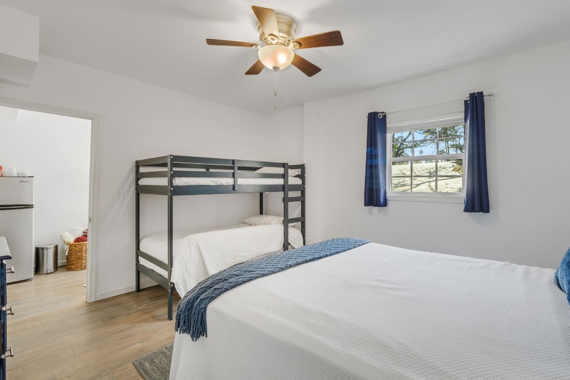 171 Kings Way Coldspring, TX 77331 - Photo 32 of 50 a bedroom with a bed and a chandelier