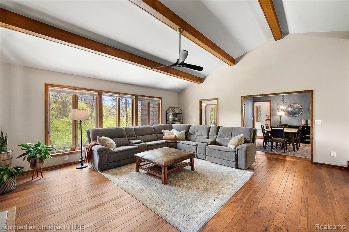 1071 Woodbridge Lane Rochester, MI 48306 - Photo 10 of 76 Living area featuring a ceiling fan, hardwood / wood-style floors, and vaulted ceiling with beams
