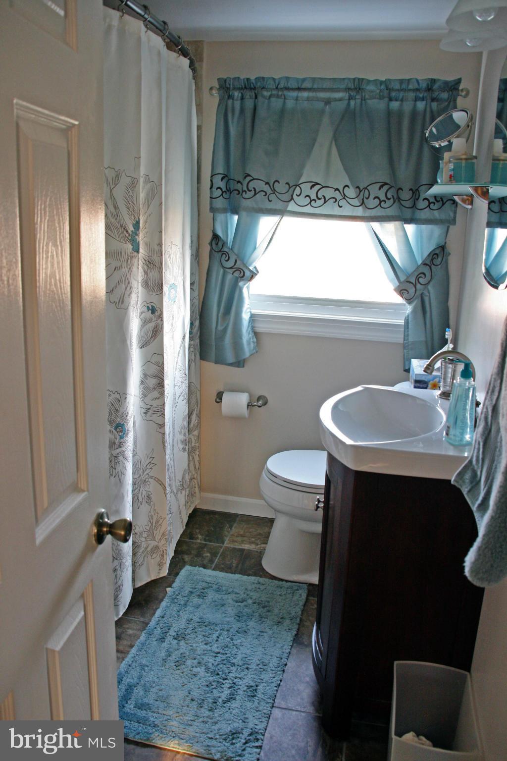 2018 Ormand Road Baltimore, MD 21222 - Photo 16 of 21 a bathroom with a sink a toilet and a mirror