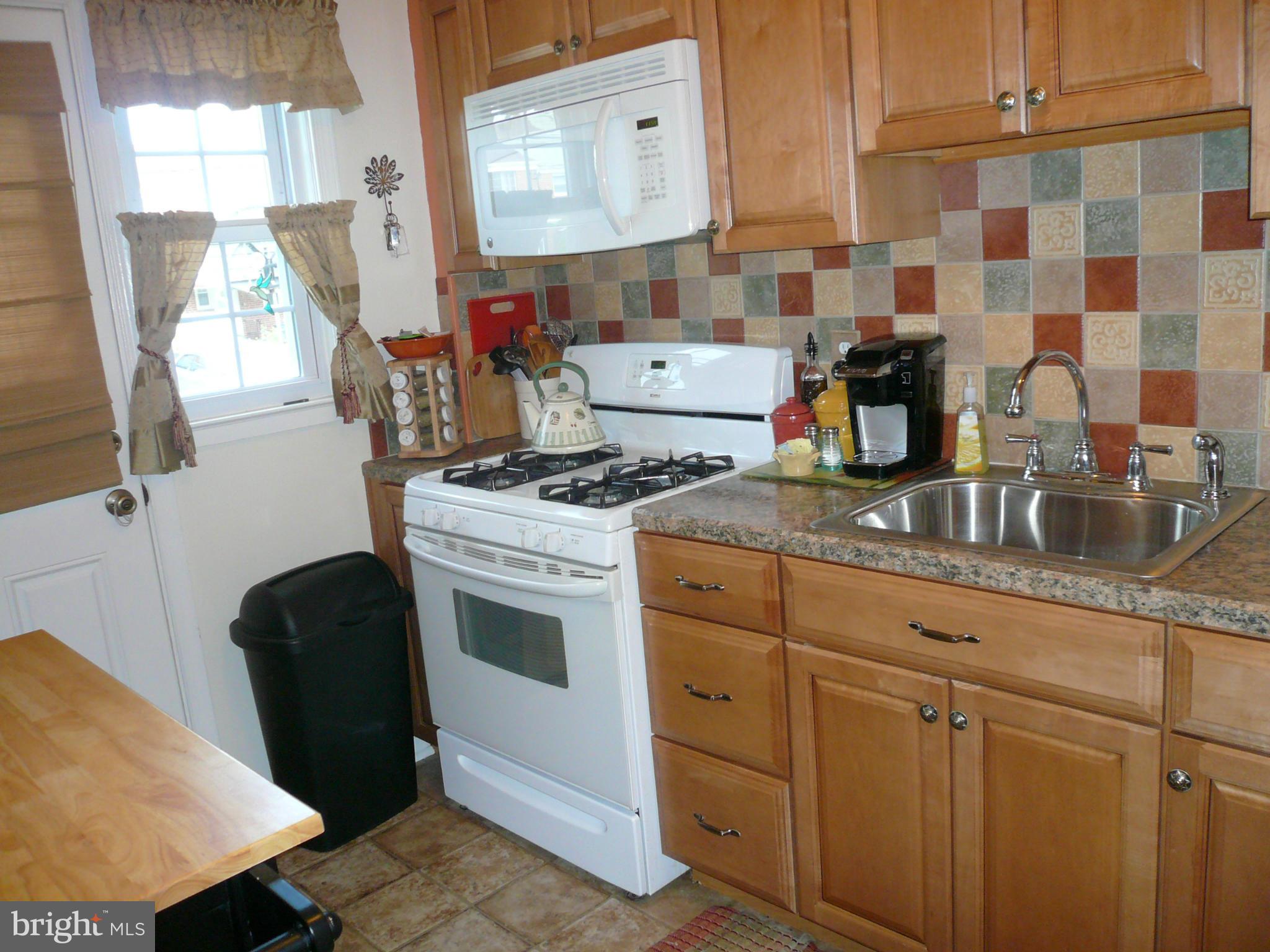 2018 Ormand Road Baltimore, MD 21222 - Photo 9 of 21 a kitchen with stainless steel appliances granite countertop a sink stove and cabinets