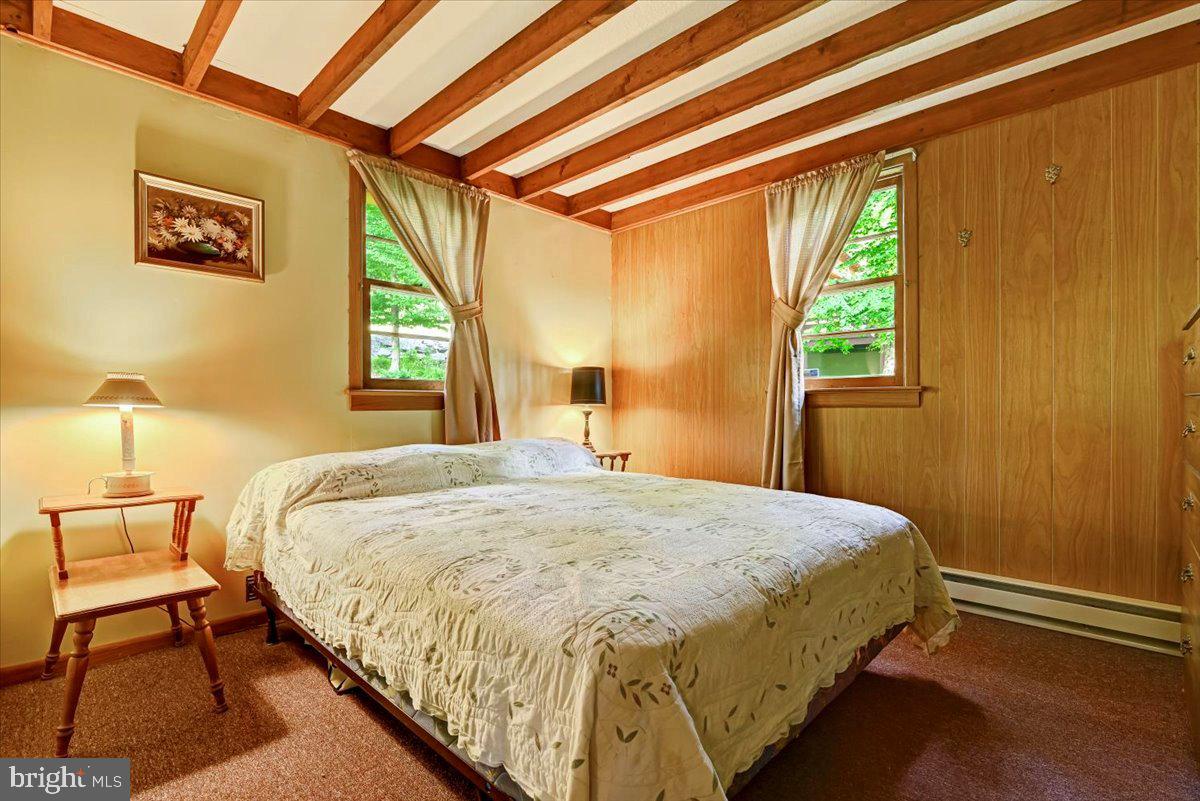112 Beechwood Cove Road Greentown, PA 18426 - Photo 14 of 59 a bedroom with a bed and wooden floor
