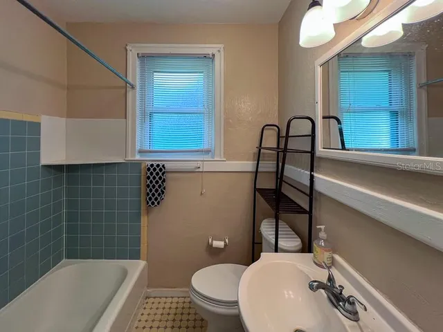 a bathroom with a sink a toilet and bathtub