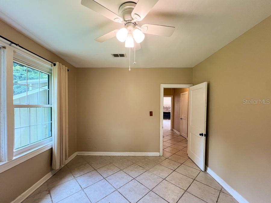 1033 Northwest 22nd Avenue Gainesville, FL 32609 - Photo 15 of 25 wooden floor in an empty room with a window