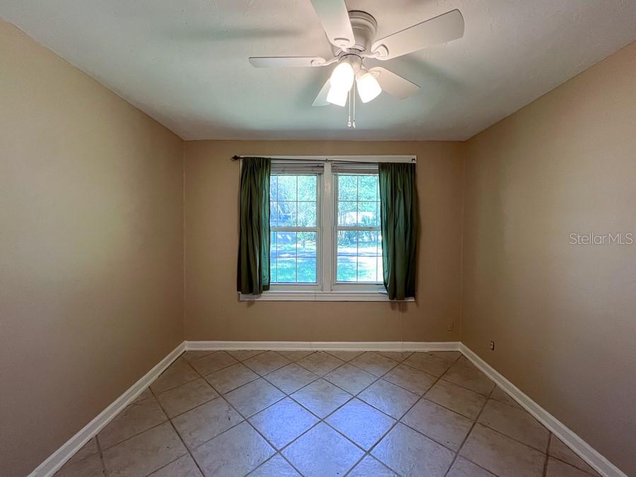 1033 Northwest 22nd Avenue Gainesville, FL 32609 - Photo 16 of 25 an empty room with windows and fan