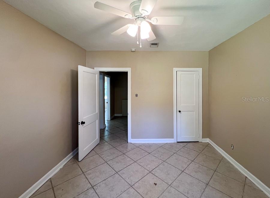 1033 Northwest 22nd Avenue Gainesville, FL 32609 - Photo 17 of 25 a view of an empty room and window chandelier fan