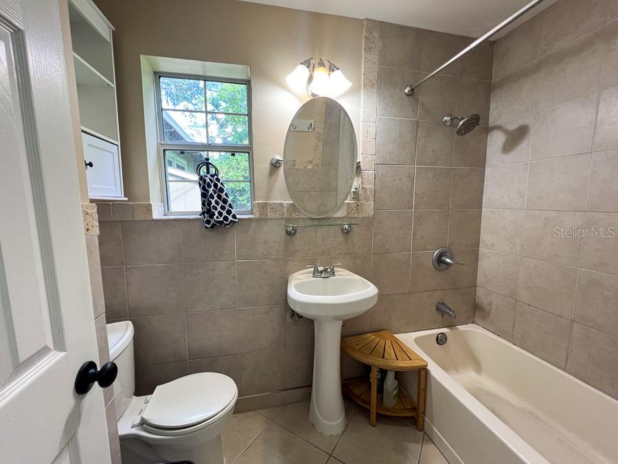 1033 Northwest 22nd Avenue Gainesville, FL 32609 - Photo 22 of 25 a bathroom with a sink a toilet and a bathtub