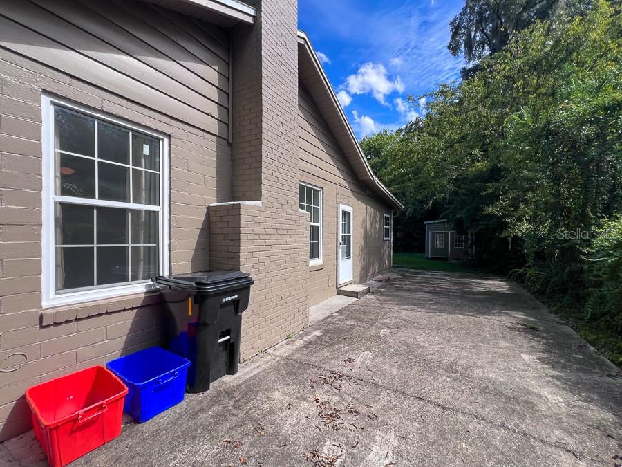 1033 Northwest 22nd Avenue Gainesville, FL 32609 - Photo 24 of 25 a view of backyard with window and outdoor seating