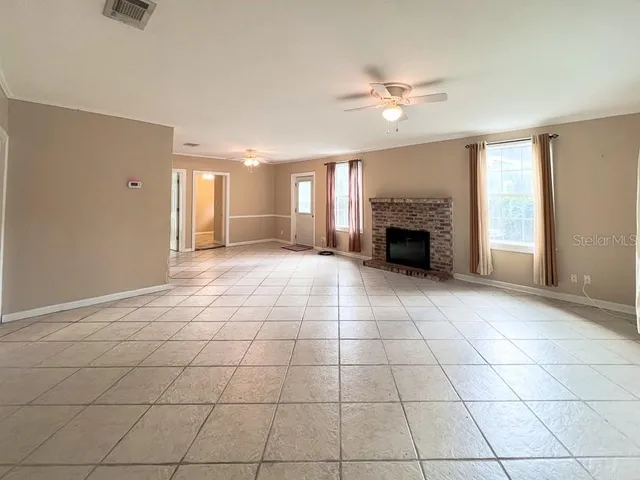 a view of an empty room with a fireplace