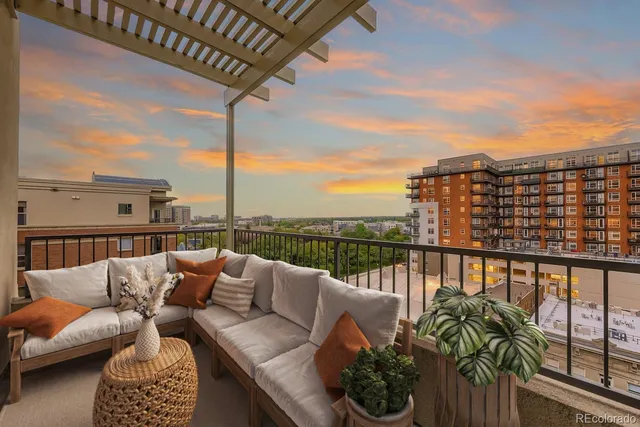a balcony with furniture and city view
