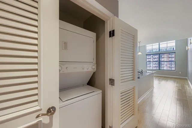 a view of washer and dryer with wooden floor