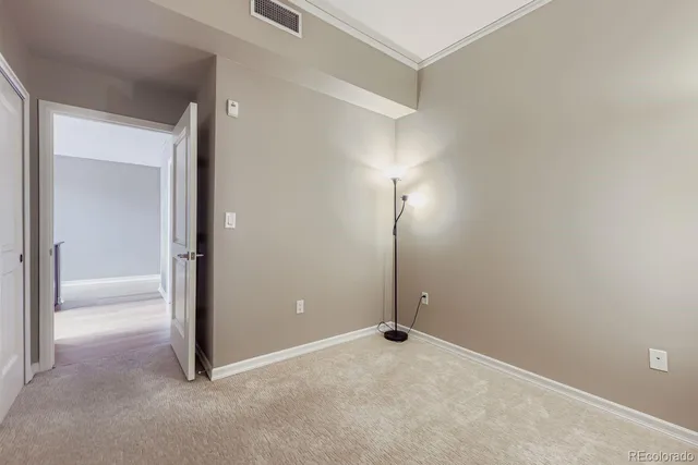 an empty room with closet area