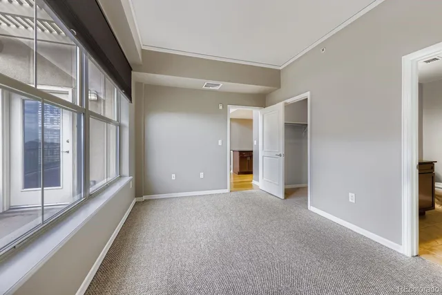a view of an empty room with a window and stairs