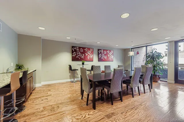 a dining room with furniture a rug and wooden floor