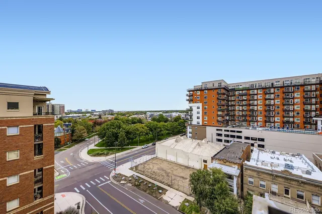 a view of a patio with couches and city view