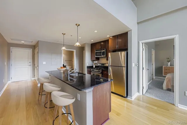 a kitchen with stainless steel appliances granite countertop a refrigerator and a sink