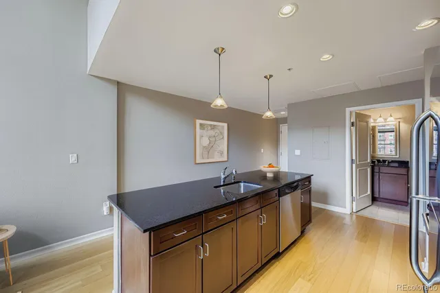 a kitchen with a sink and refrigerator
