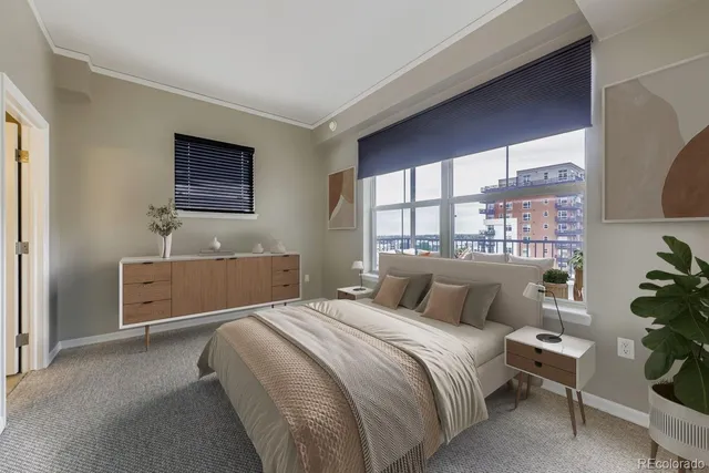 a bedroom with a bed and a large window