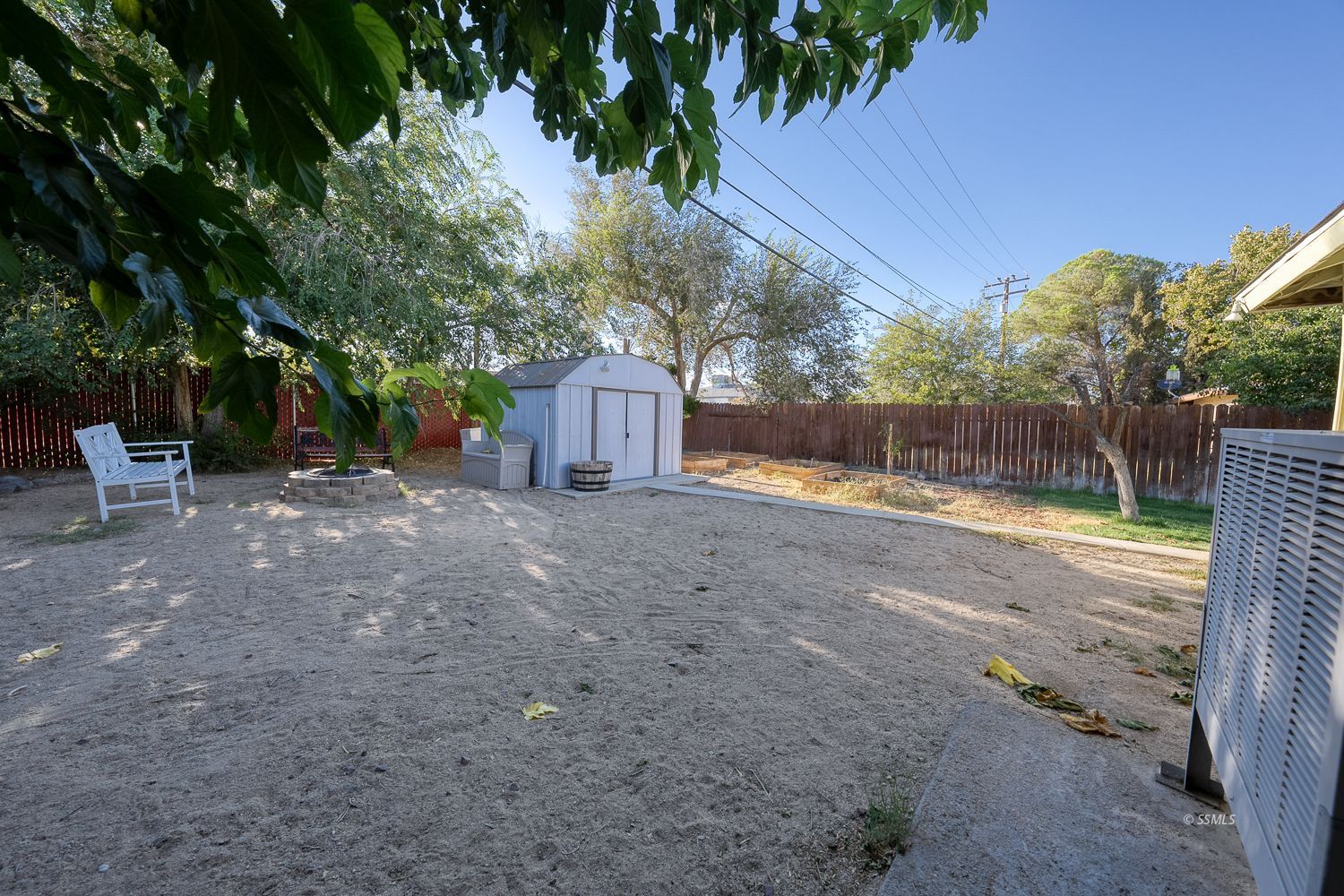 617 South Downs Street Ridgecrest, CA 93555 - Photo 29 of 34 a view of a backyard with large tree and wooden fence