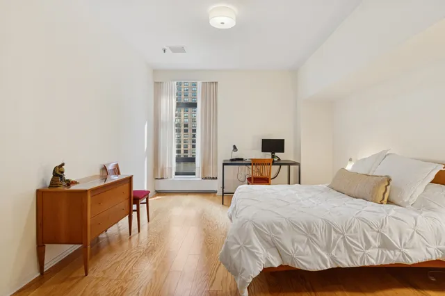 a bedroom with a bed and a desk