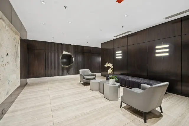 a lobby with furniture and lamp