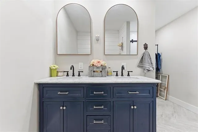 a bathroom with 2 sink and a mirror