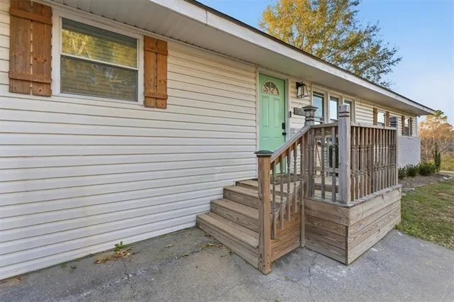 a view of a house with large windows and stairs