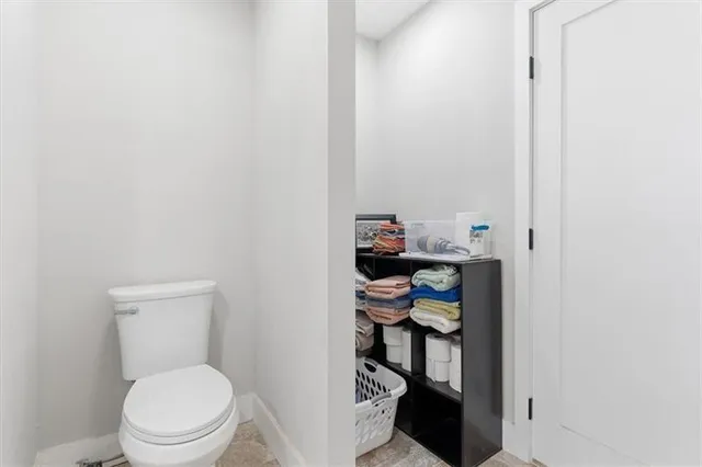 a white toilet sitting next to a bathroom sink