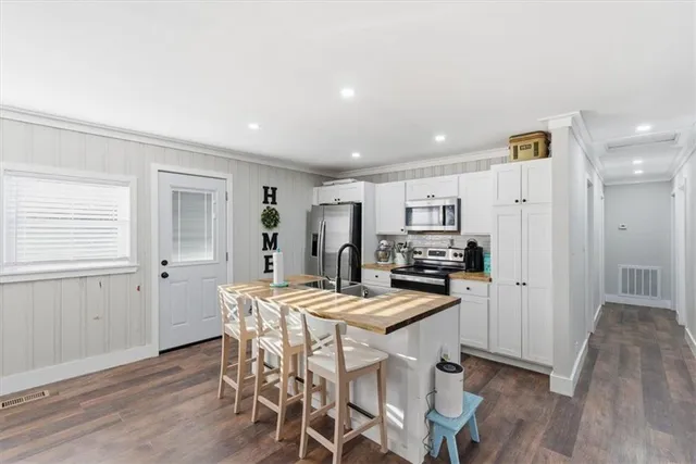 a bathroom with a sink toilet and a mirror