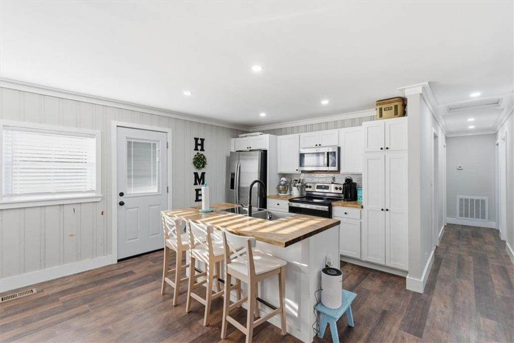 121 Ripley Avenue Adairsville, GA 30103 - Photo 8 of 43 a kitchen with stainless steel appliances kitchen island granite countertop a refrigerator and a stove top oven
