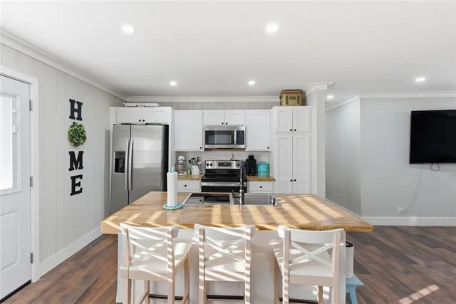 a view of cabinets a sink and a window in a bathroom