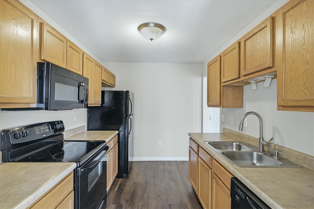 703 Bellview Way Seneca, SC 29678 - Photo 9 of 23 Warm oak cabinetry pairs with clean countertops and durable flooring in this practical kitchen layout.