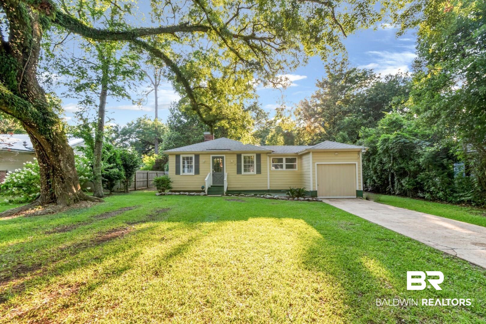 263 Border Drive East Mobile, AL 36608 - Photo 26 of 27 Exterior featuring light yellow siding, dark green shutters, a single-car garage, and a concrete driveway
