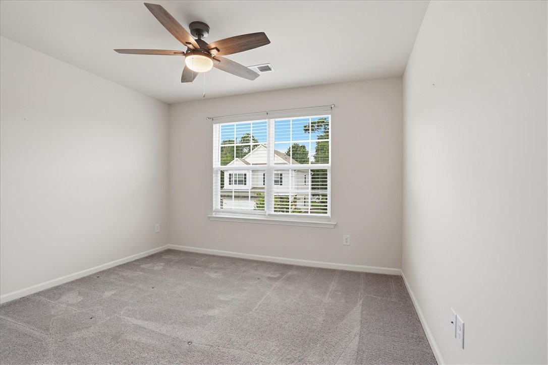 365 Sliding Rock Drive Pendleton, SC 29670 - Photo 21 of 46 Well-lit room featuring soft gray carpeting and a contemporary ceiling fan, ideal for comfort.